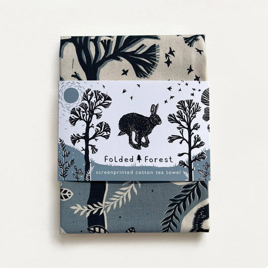 Cotton tea towel with forest design and rabbit illustration on a white background