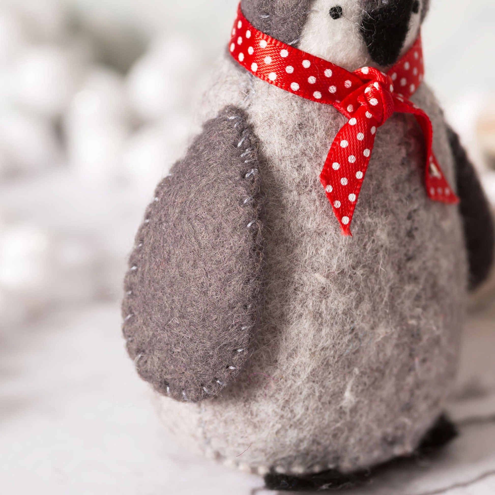 Stuffed animal with a red polka dot bow on a blurred background