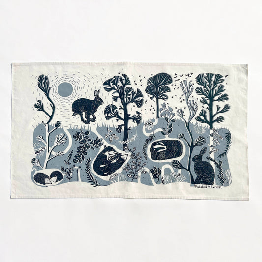 Fabric with blue animal and nature pattern on a white background
