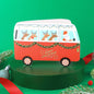 Red Christmas-themed van with reindeer and Santa on a green background