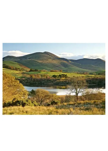 Steve Blake Photography Greetings Cards featuring a picturesque view of the Lake District landscape with rolling hills and a serene lake.