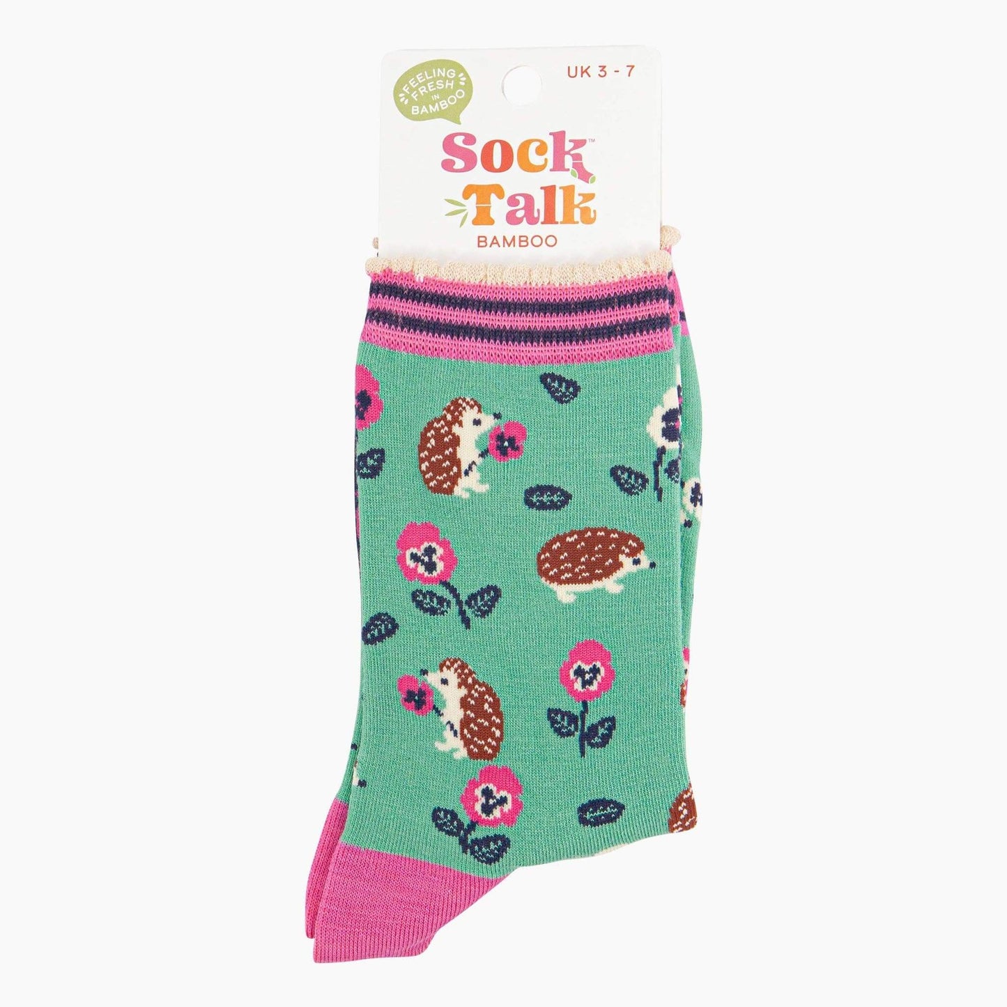 Green socks with hedgehog and flower pattern on a white background