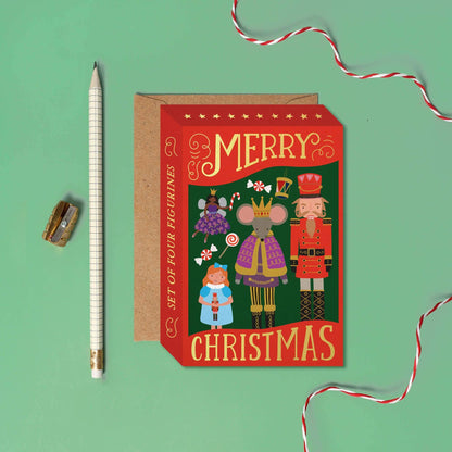 Christmas-themed product packaging with illustrations of figurines on a green background