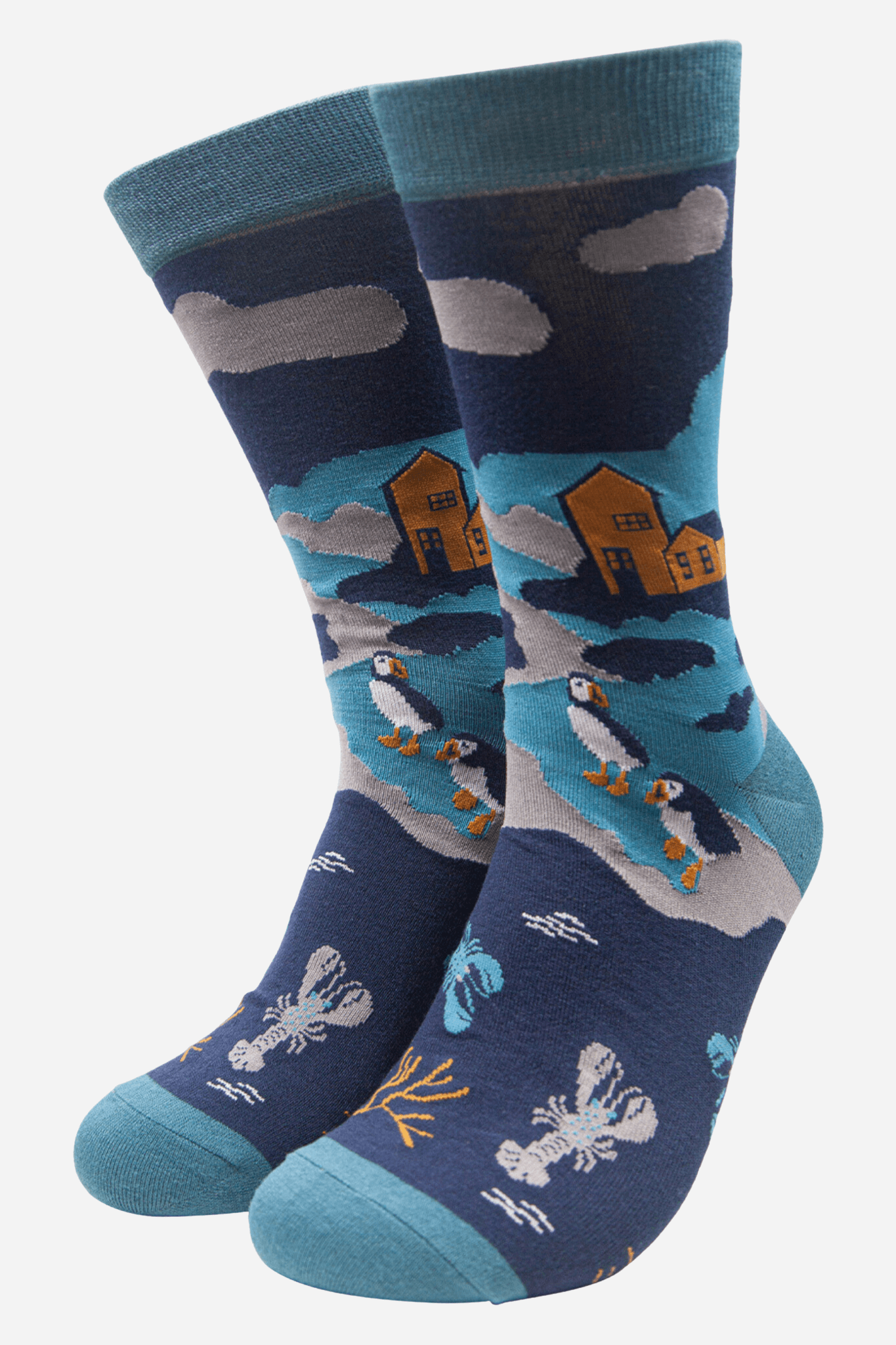 Pair of socks with penguin and lobster design on a blue background