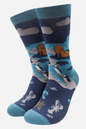Pair of socks with penguin and lobster design on a blue background
