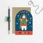 Greeting card with a polar bear illustration and 'Warm Wishes' text, accompanied by a pencil and decorative string on a light gray background.