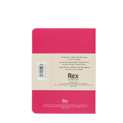 Pink notebook with beige label displaying text and branding on a white background