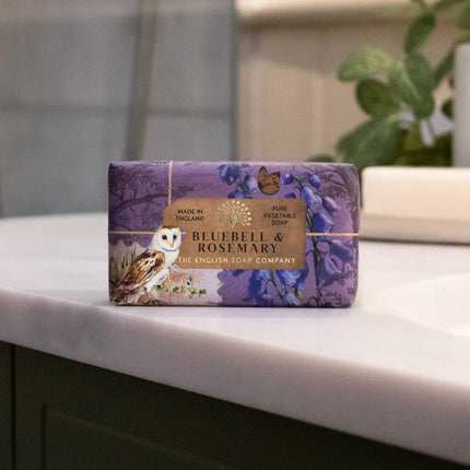 Purple soap bar with 'Bluebell & Rosemary' packaging on a bathroom counter.