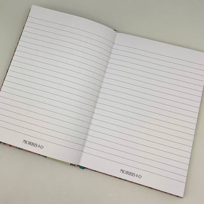 Open notebook with lined pages on a light gray background