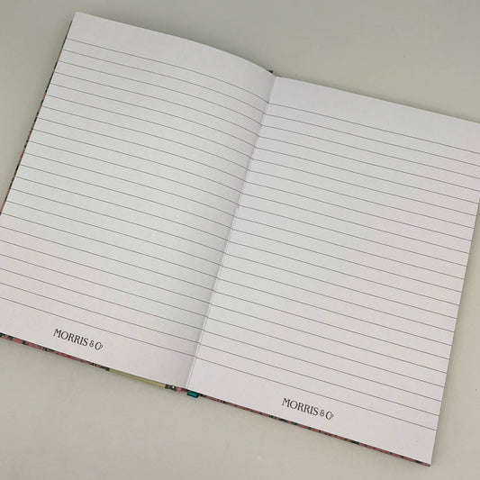 Open notebook with lined pages on a light gray background