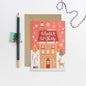 Christmas card with gingerbread house design and 'Winter Wishes' text, accompanied by a pencil and decorative string.