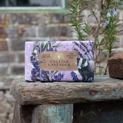 English Lavender soap bar with packaging on a wooden surface outdoors