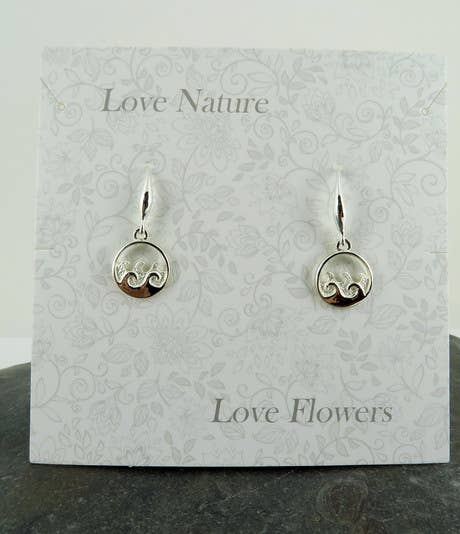 Silver earrings on a 'Love Nature Love Flowers' card