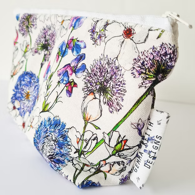 Floral-patterned pouch with a visible brand name on a white background