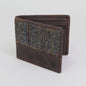 Brown wallet with patterned flap on a light gray background