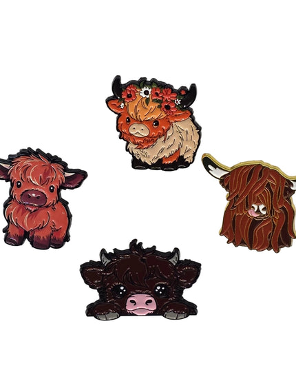 Four highland cow pins on a light gray background