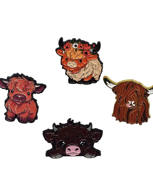 Four highland cow pins on a light gray background