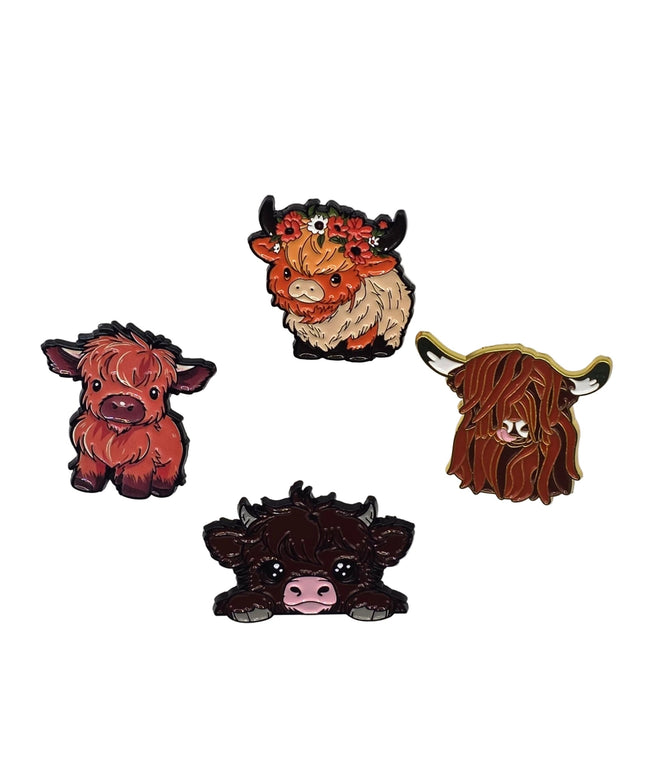 Four highland cow pins on a light gray background