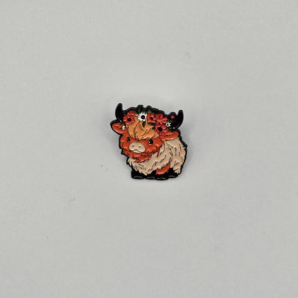Small cow pin on a gray background
