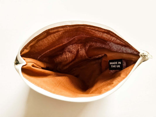 Brown fabric in a white container with 'Made in the UK' label on a white background