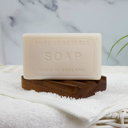 Bar of pure vegetable soap on a wooden stand with a marble background