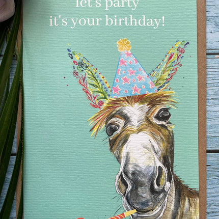 Birthday card with a donkey wearing a party hat and the text 'let's party it's your birthday!' on a teal background.