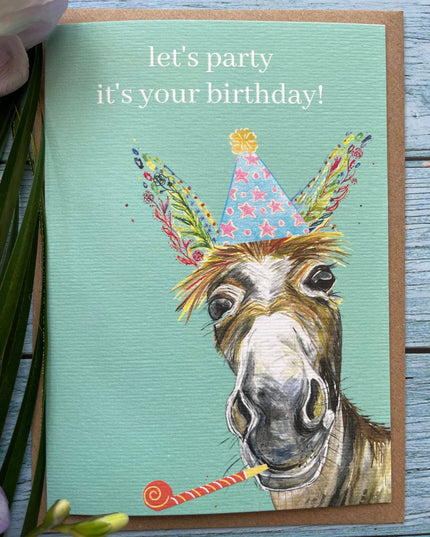 Birthday card with a donkey wearing a party hat and the text 'let's party it's your birthday!' on a teal background.