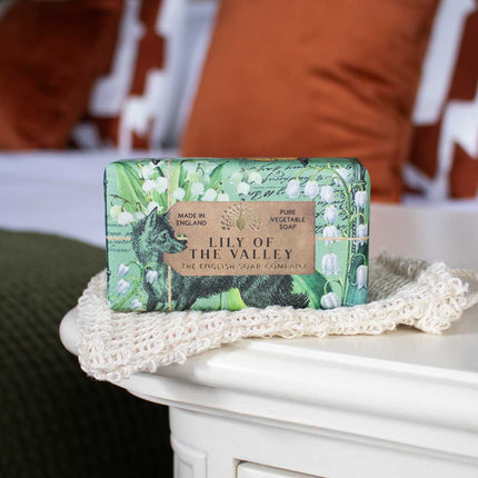 Bar of soap with 'Lily of the Valley' packaging on a textured surface