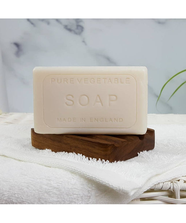 Bar of pure vegetable soap on a wooden stand with a marble background