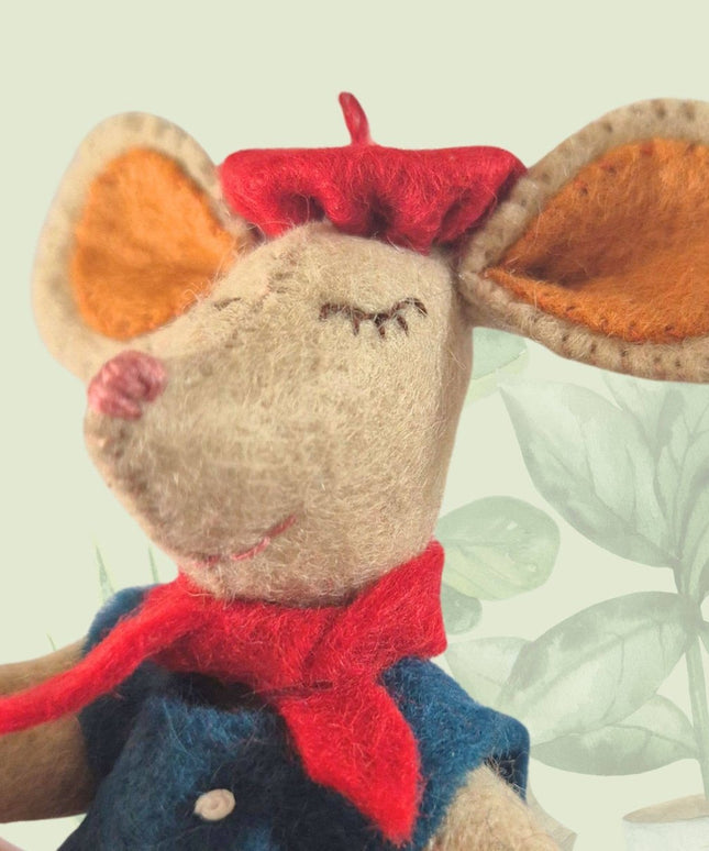 Stuffed mouse toy with a red bow tie and blue vest on a light background
