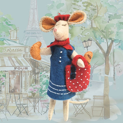 Stuffed mouse toy in a Parisian setting with Eiffel Tower in the background
