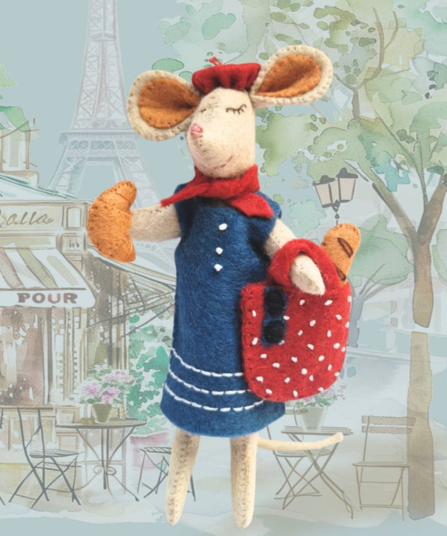 Stuffed mouse toy in a Parisian setting with Eiffel Tower in the background