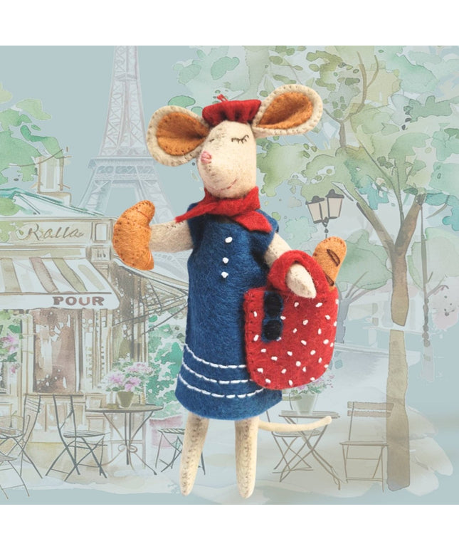 Stuffed mouse toy in a Parisian setting with Eiffel Tower in the background