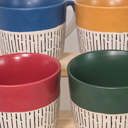 Four ceramic mugs with a white and black brushstroke pattern