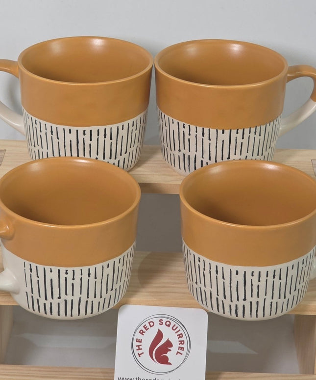 Four ceramic mugs with tan interiors and white exteriors featuring black horizontal stripes.