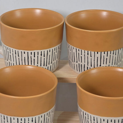 Four ceramic planters with warm tan interiors