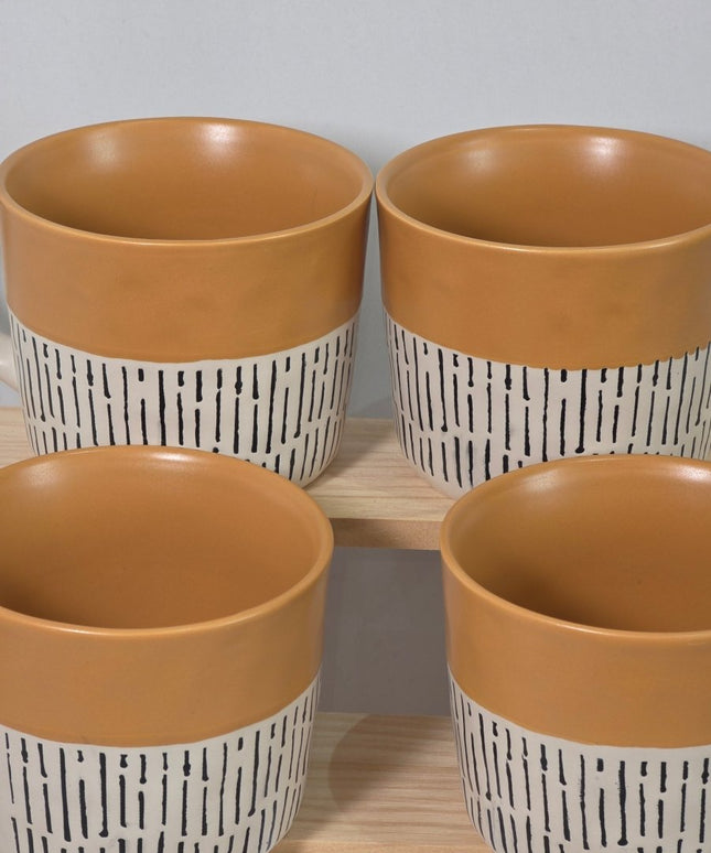 Four ceramic planters with warm tan interiors