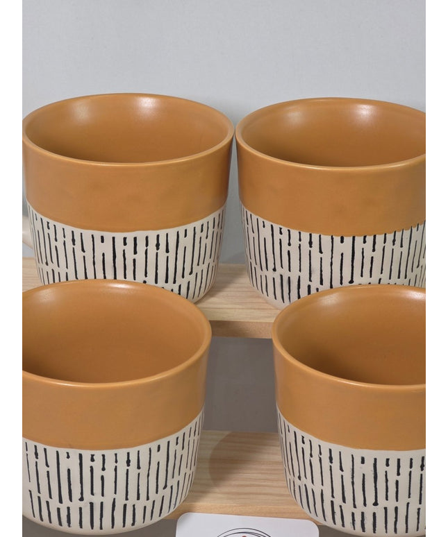 Four ceramic planters with warm tan interiors