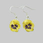 Yellow flower earrings with silver hooks on a gray background