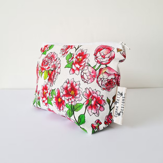 Floral-patterned pouch with a visible brand tag on a white background