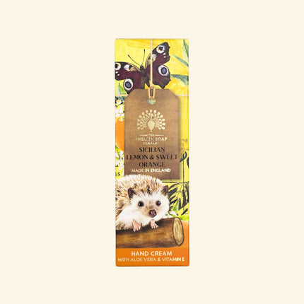 Hand cream packaging with hedgehog, butterflies, and lemon design on a beige background