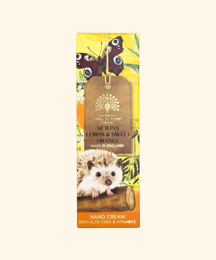 Hand cream packaging with hedgehog, butterflies, and lemon design on a beige background