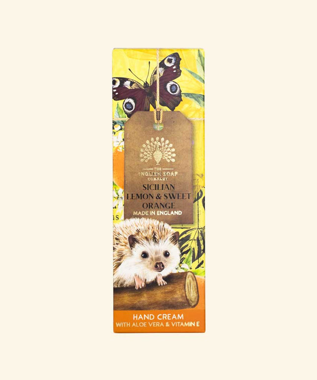 Hand cream packaging with hedgehog, butterflies, and lemon design on a beige background
