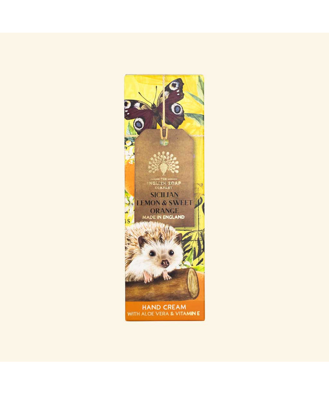 Hand cream packaging with hedgehog, butterflies, and lemon design on a beige background