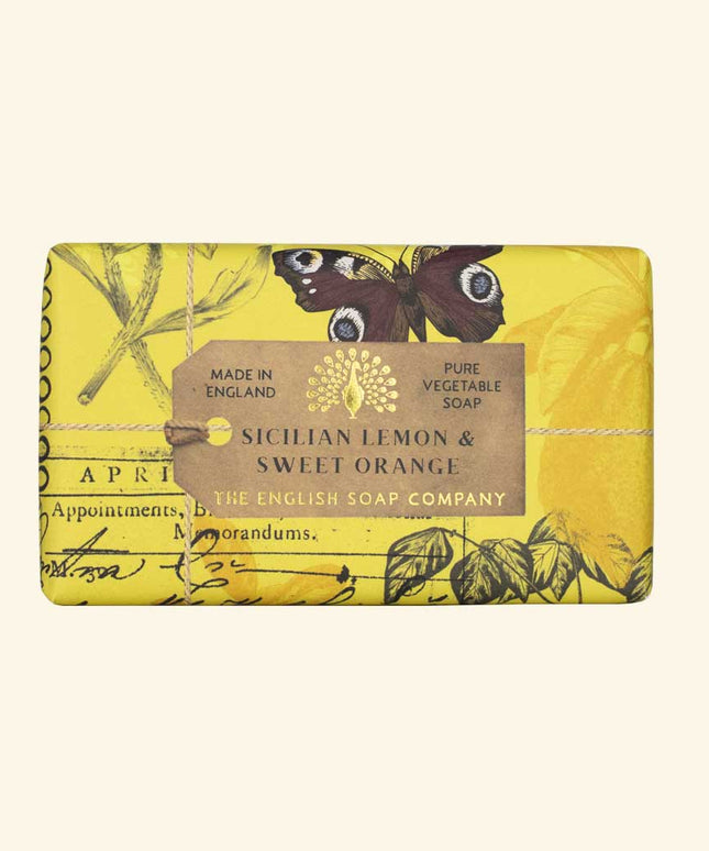 Yellow soap bar with botanical design and label on a beige background
