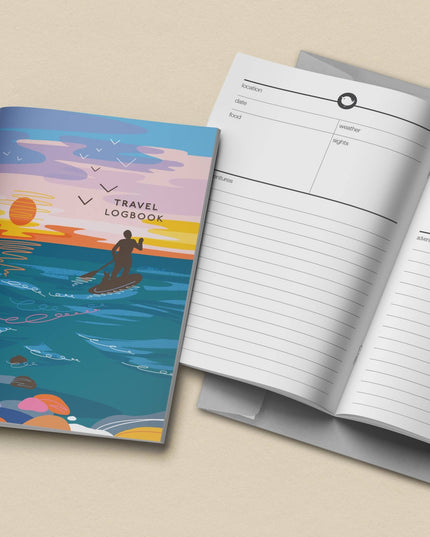 Travel logbook with a colorful cover and open to show lined pages on a beige background