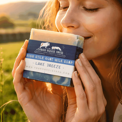Woman holding a bar of soap with 'Cragg House Farm' branding against a natural background