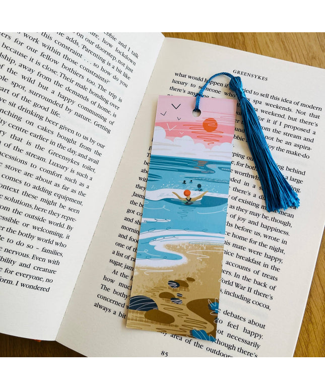 Bookmark with beach design on an open book